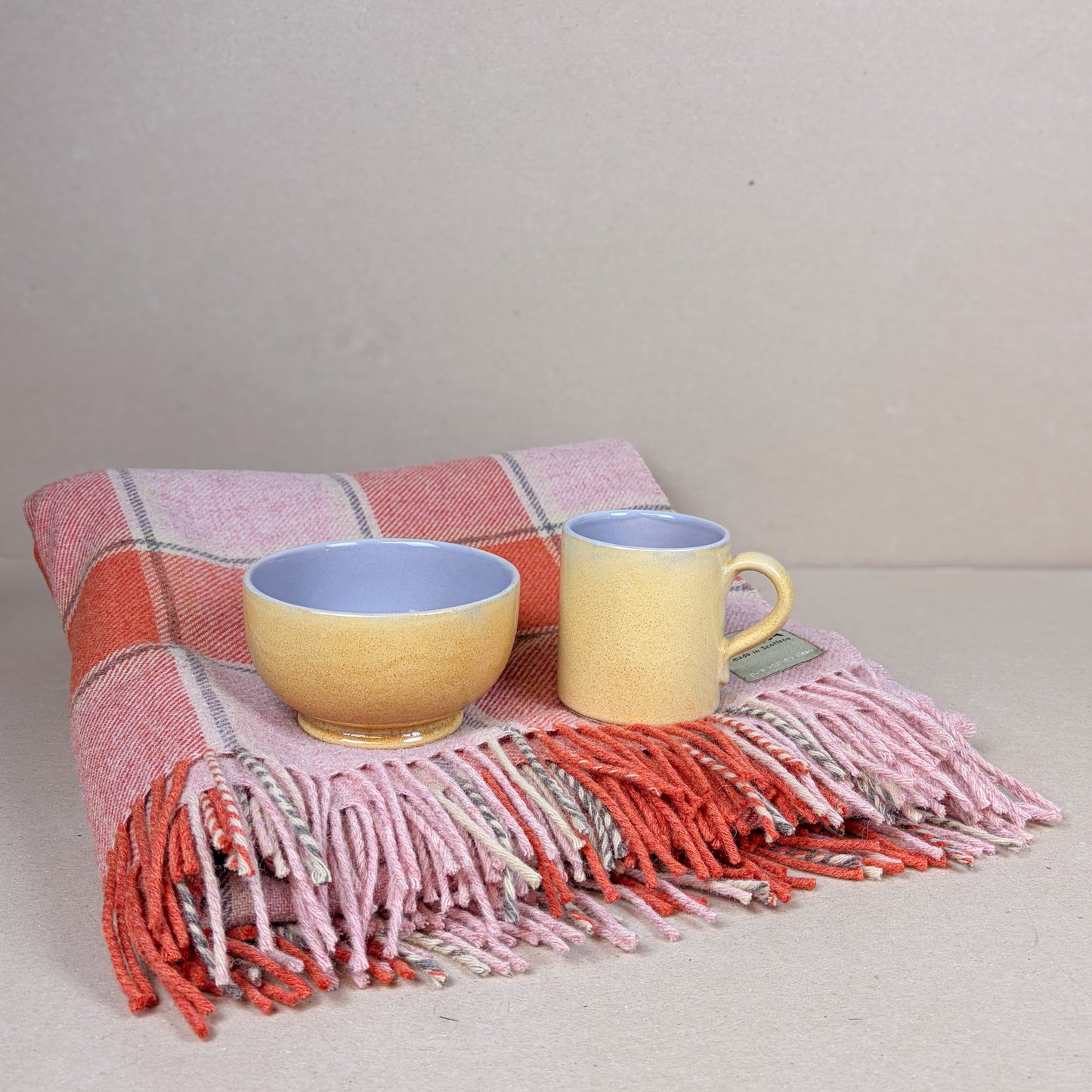 Elizabeth Pirrie Throw with a Large Canary Mug and Porridge Bowl